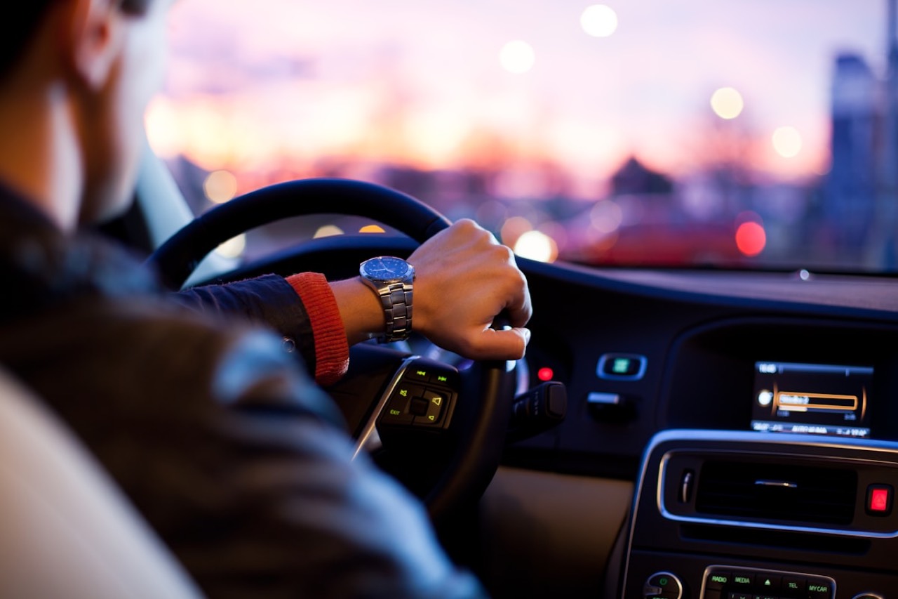 Driver at the wheel on a city road at night