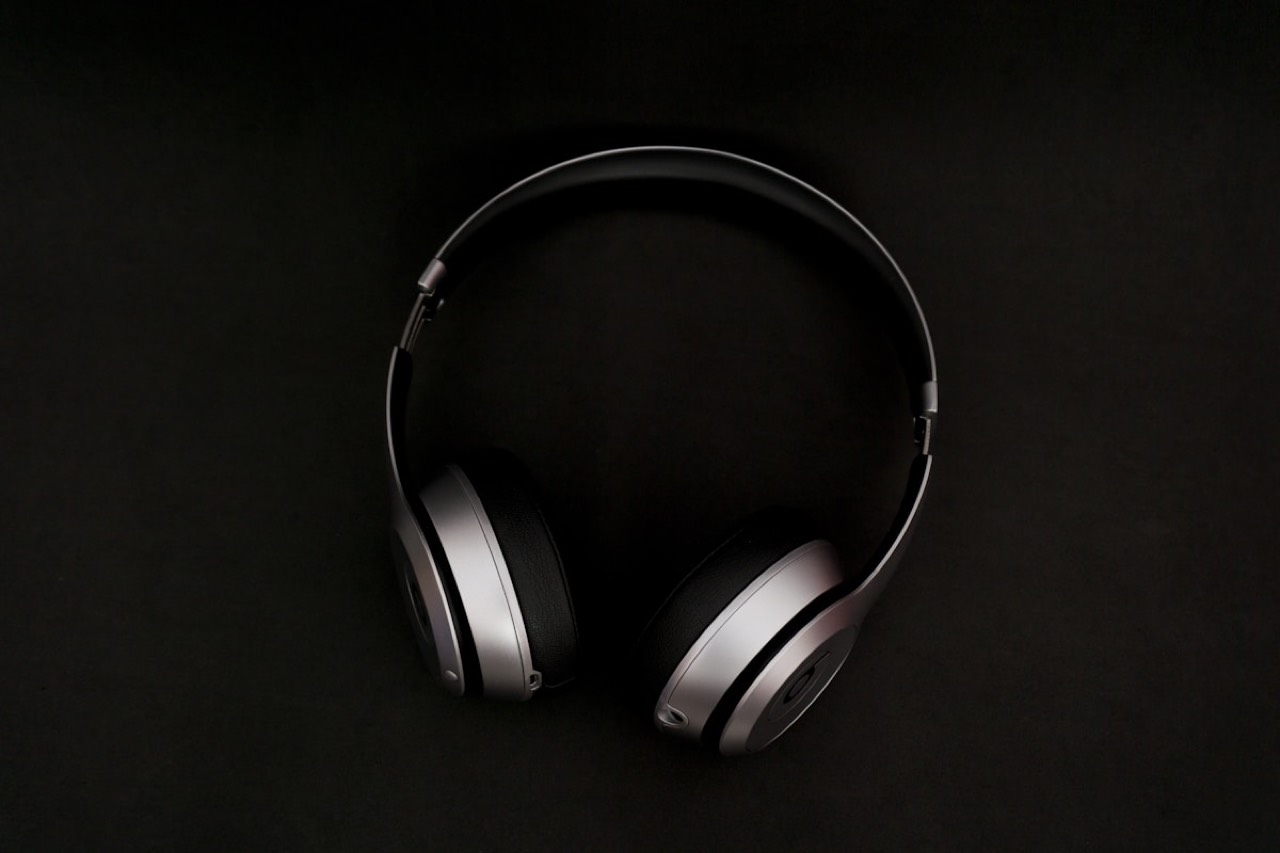 Audeze planar-magnetic headphones with silver earcups on a dark background