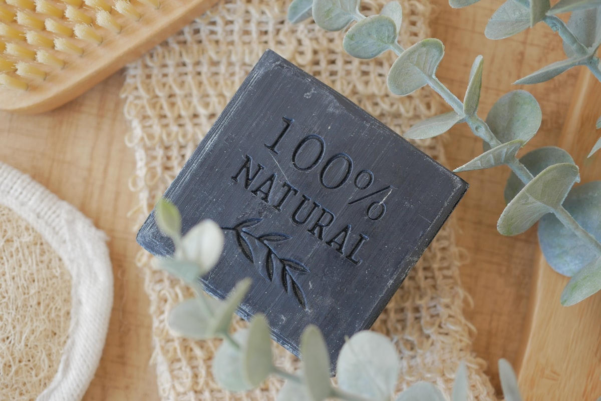 A bar of soap resting on a wooden dish