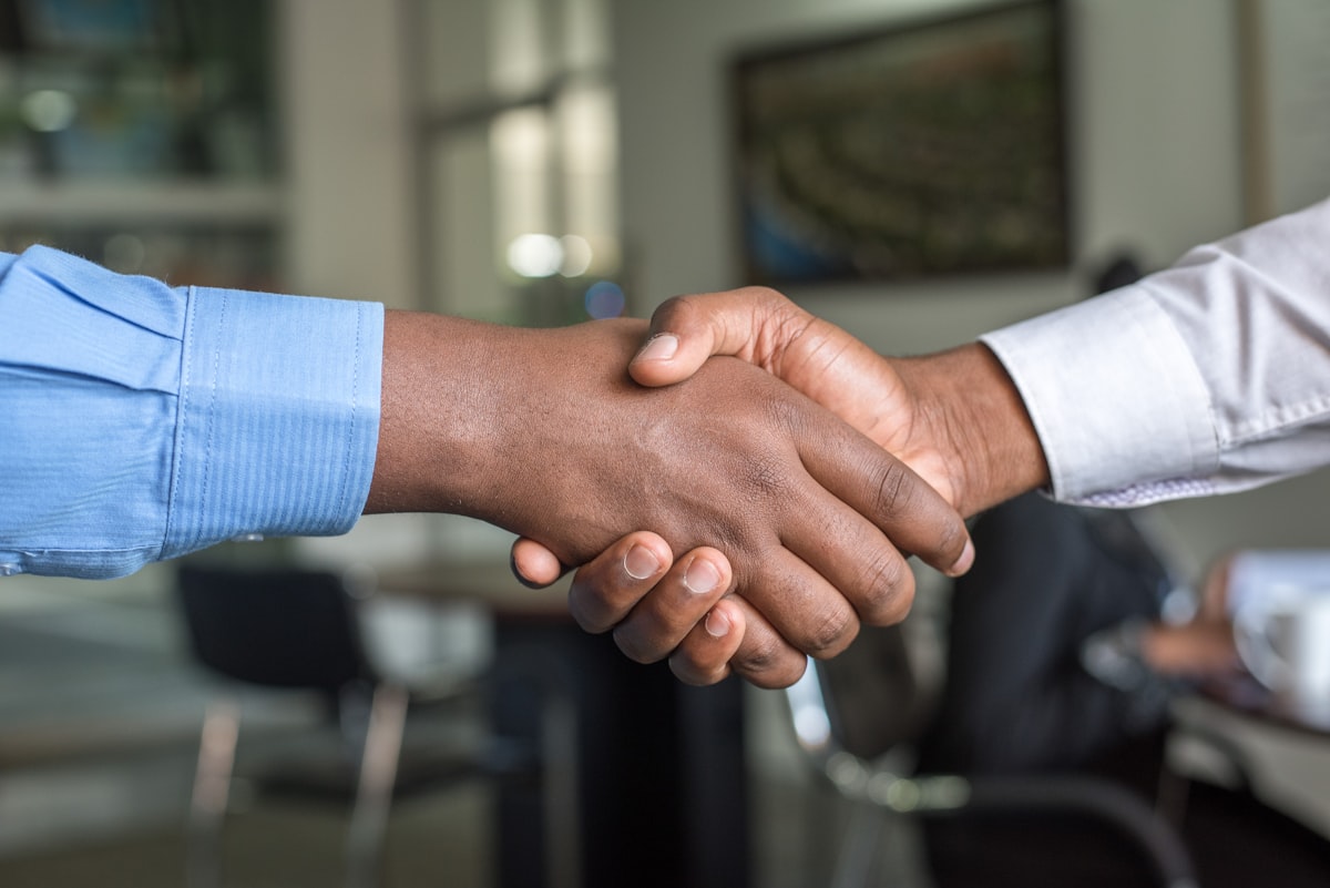Two people shaking hands in a business setting