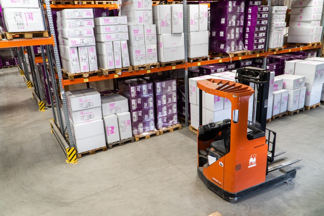 Shopee Brazil warehouse interior with shelves of packages and a forklift