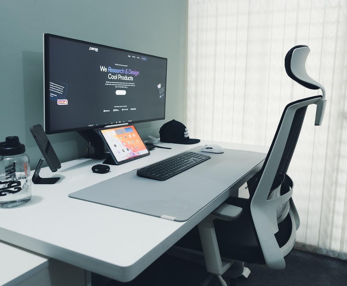 A modern desk setup with computer and ergonomic chair