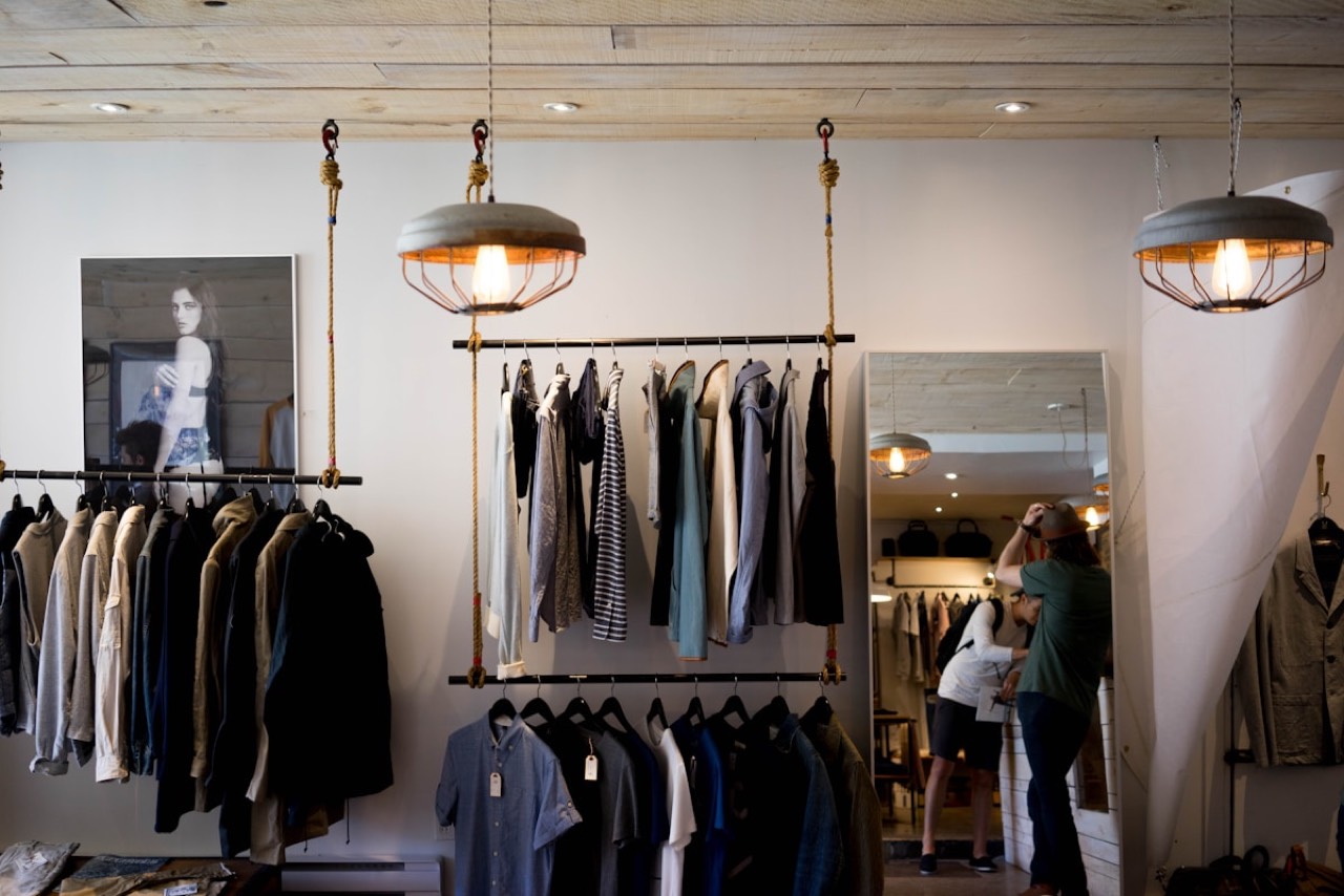 Designer boutique with pendant lighting and browsing shoppers